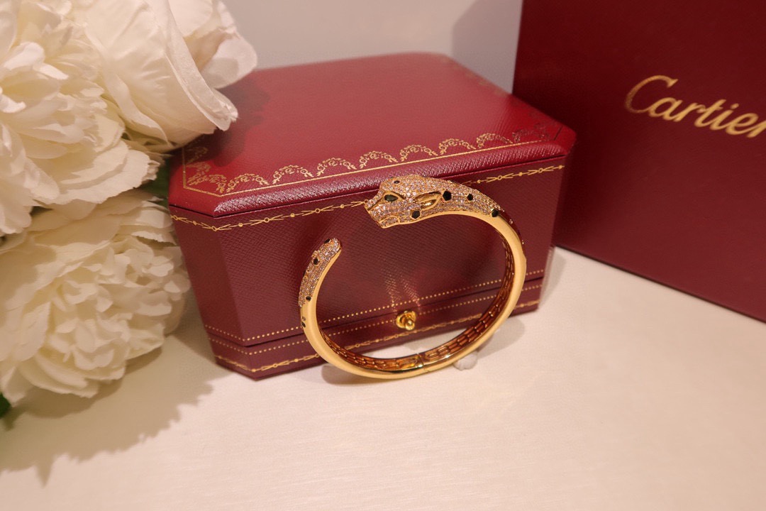 Cartier Panthere de Cartier bracelet 18K yellow gold set with diamonds black onyx spots tsavorite garnet eyes 17