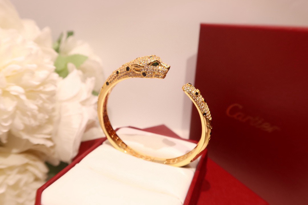 Cartier Panthere de Cartier bracelet 18K yellow gold set with diamonds black onyx spots tsavorite garnet eyes 17