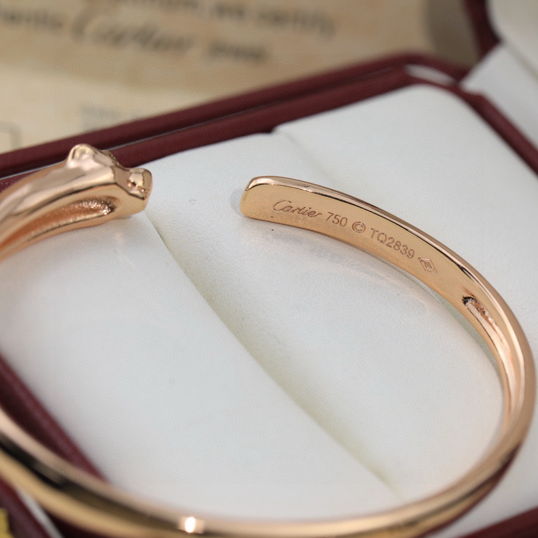 Cartier Panthere de Cartier bracelet 18K yellow gold 18K rose gold 18K white gold with green tsavorite garnet eyes and black onyx nose accents 17
