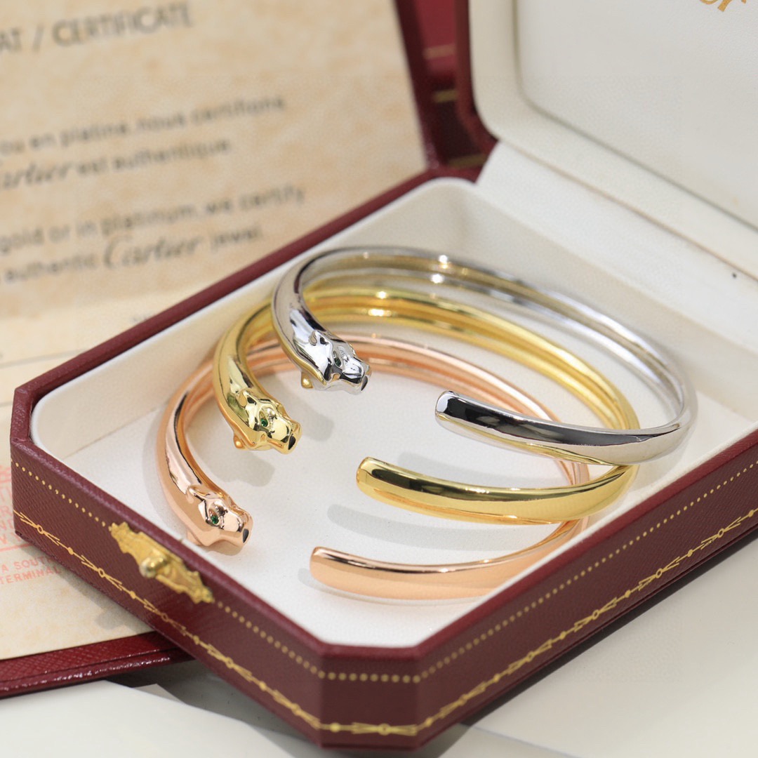Cartier Panthere de Cartier bracelet 18K yellow gold 18K rose gold 18K white gold with green tsavorite garnet eyes and black onyx nose accents 17