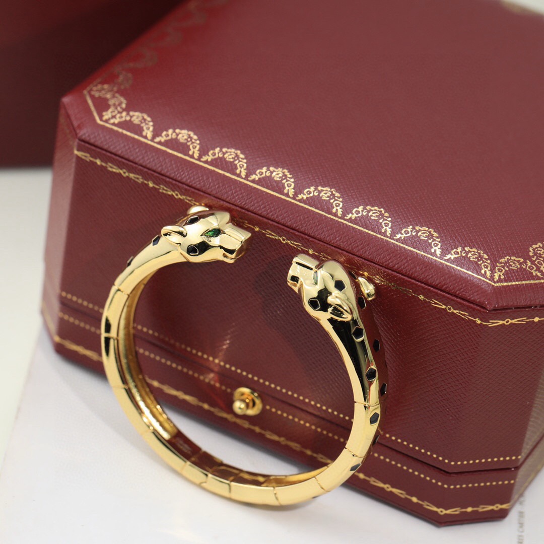 Cartier Panthere de Cartier bracelet 18K yellow gold with black lacquer spots and green tsavorite garnet eyes 17cm