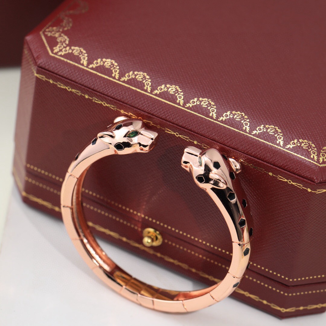 Cartier Panthere de Cartier bracelet 18K yellow gold with black lacquer spots and green tsavorite garnet eyes 17cm