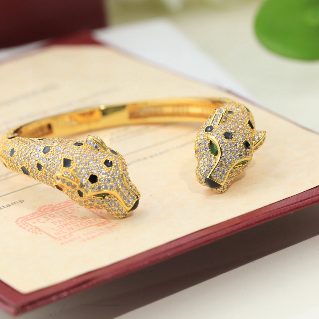 Cartier Panthere de Cartier bracelet Available in 18K yellow gold 18K rose gold and 18K white gold all fully paved with colorless diamonds accented with black onyx spots emerald eyes and black onyx nose details 17cm inner circumference