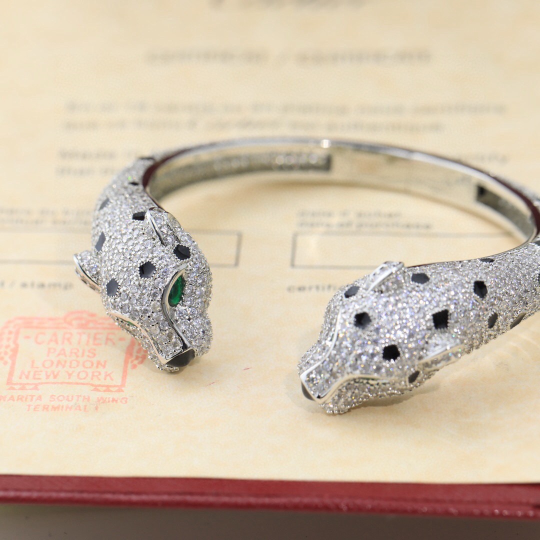 Cartier Panthere de Cartier bracelet Available in 18K yellow gold 18K rose gold and 18K white gold all fully paved with colorless diamonds accented with black onyx spots emerald eyes and black onyx nose details 17cm inner circumference