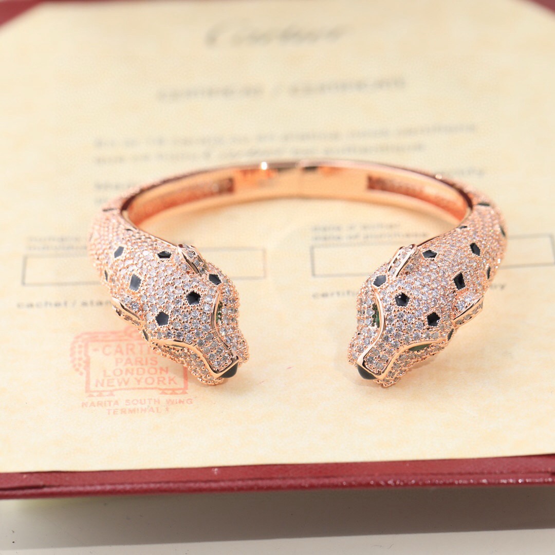 Cartier Panthere de Cartier bracelet Available in 18K yellow gold 18K rose gold and 18K white gold all fully paved with colorless diamonds accented with black onyx spots emerald eyes and black onyx nose details 17cm inner circumference