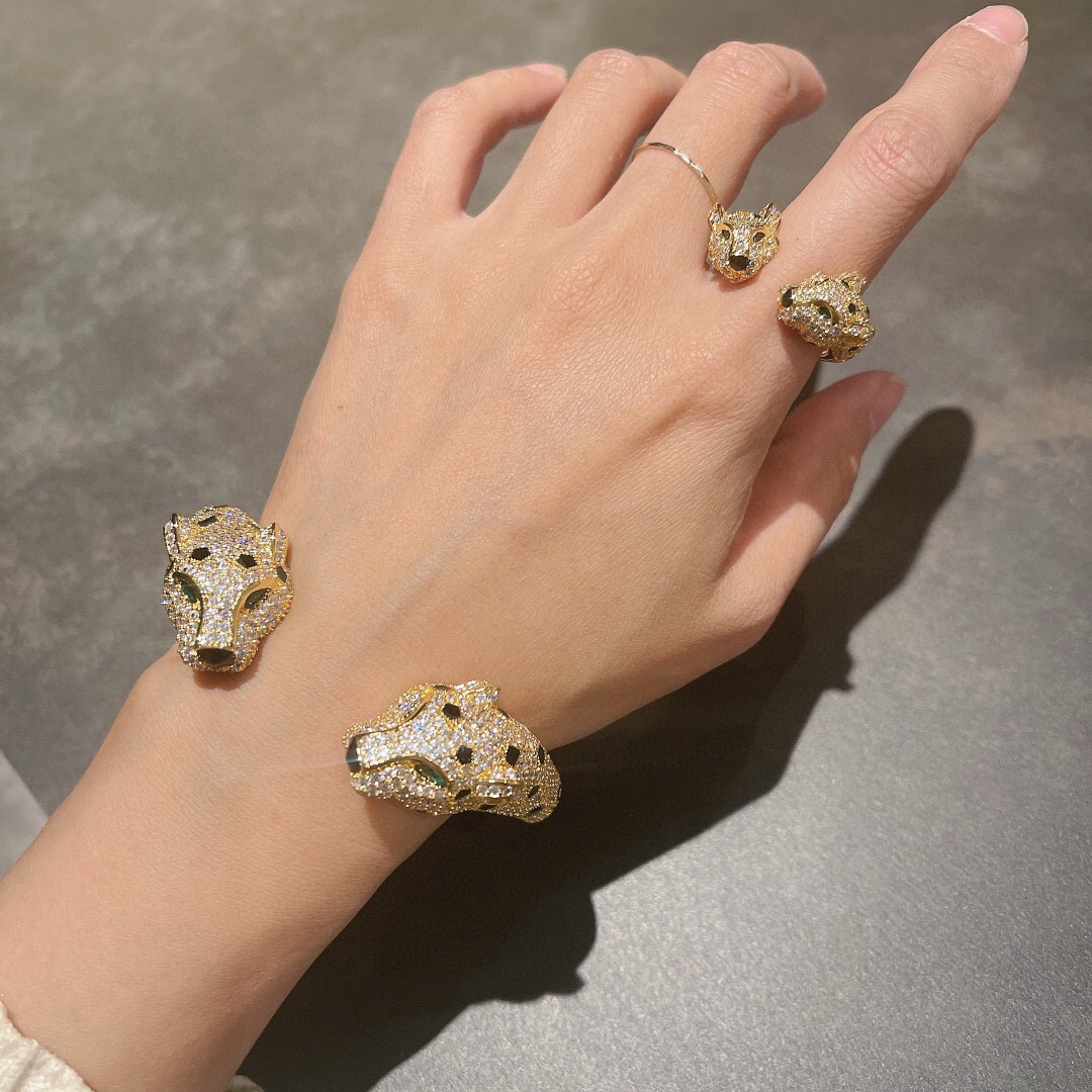 Cartier Panthere de Cartier bracelet Available in 18K yellow gold 18K rose gold and 18K white gold all fully paved with colorless diamonds accented with black onyx spots emerald eyes and black onyx nose details 17cm inner circumference