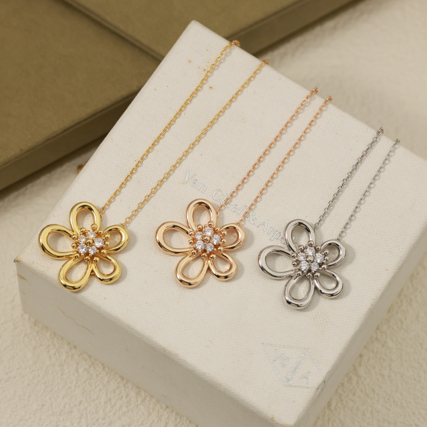 Van Cleef Arpels Flowerlace necklace 18K yellow gold with clear diamond accents 18K rose gold with clear diamond accents 18K white gold with clear diamond accents 42cm