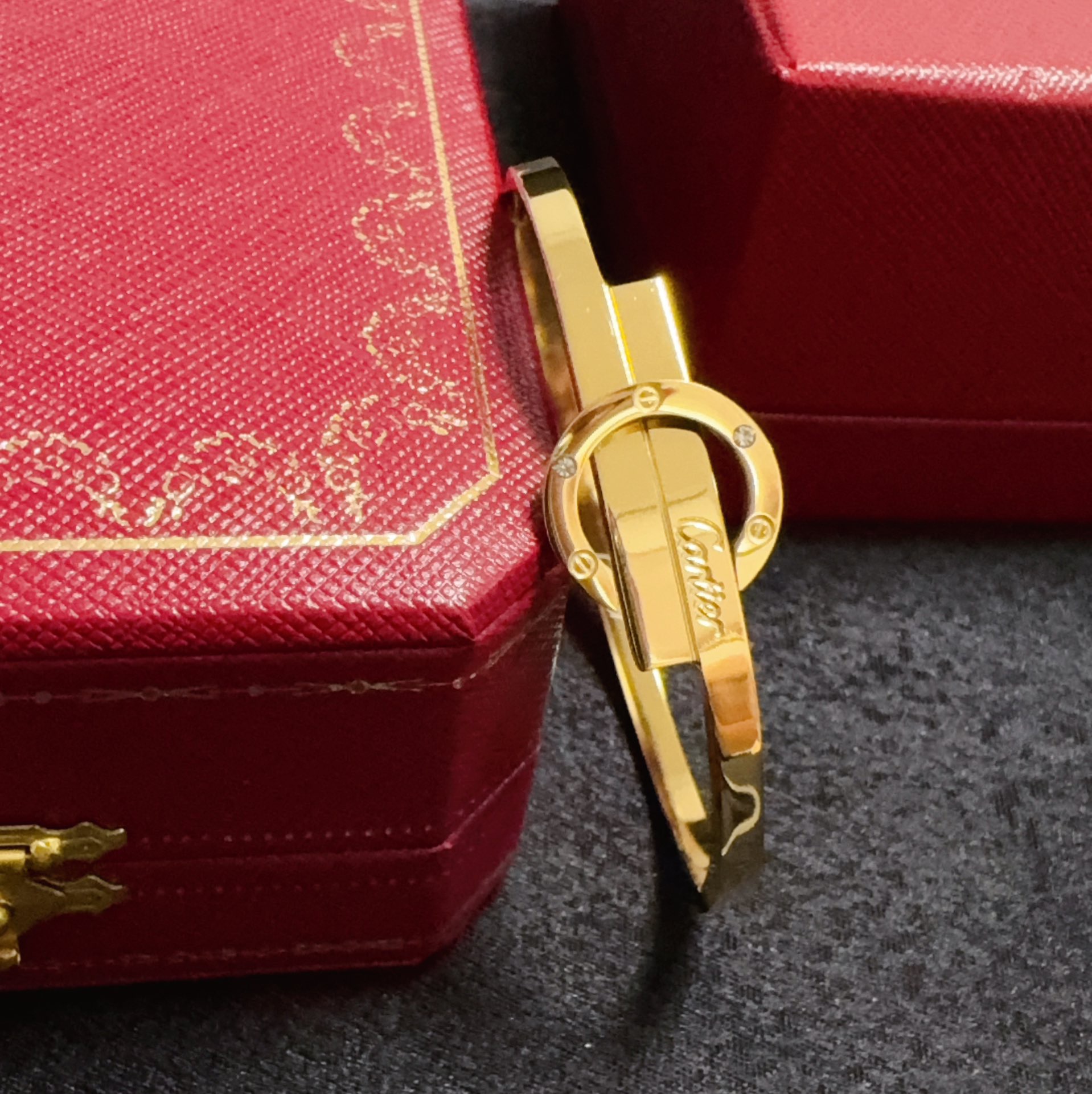 Cartier Love Interlocking Clasp Bangle bracelet 18k yellow gold with small clear diamond accents 18k white gold with small clear diamond accents 17cm inner circumference