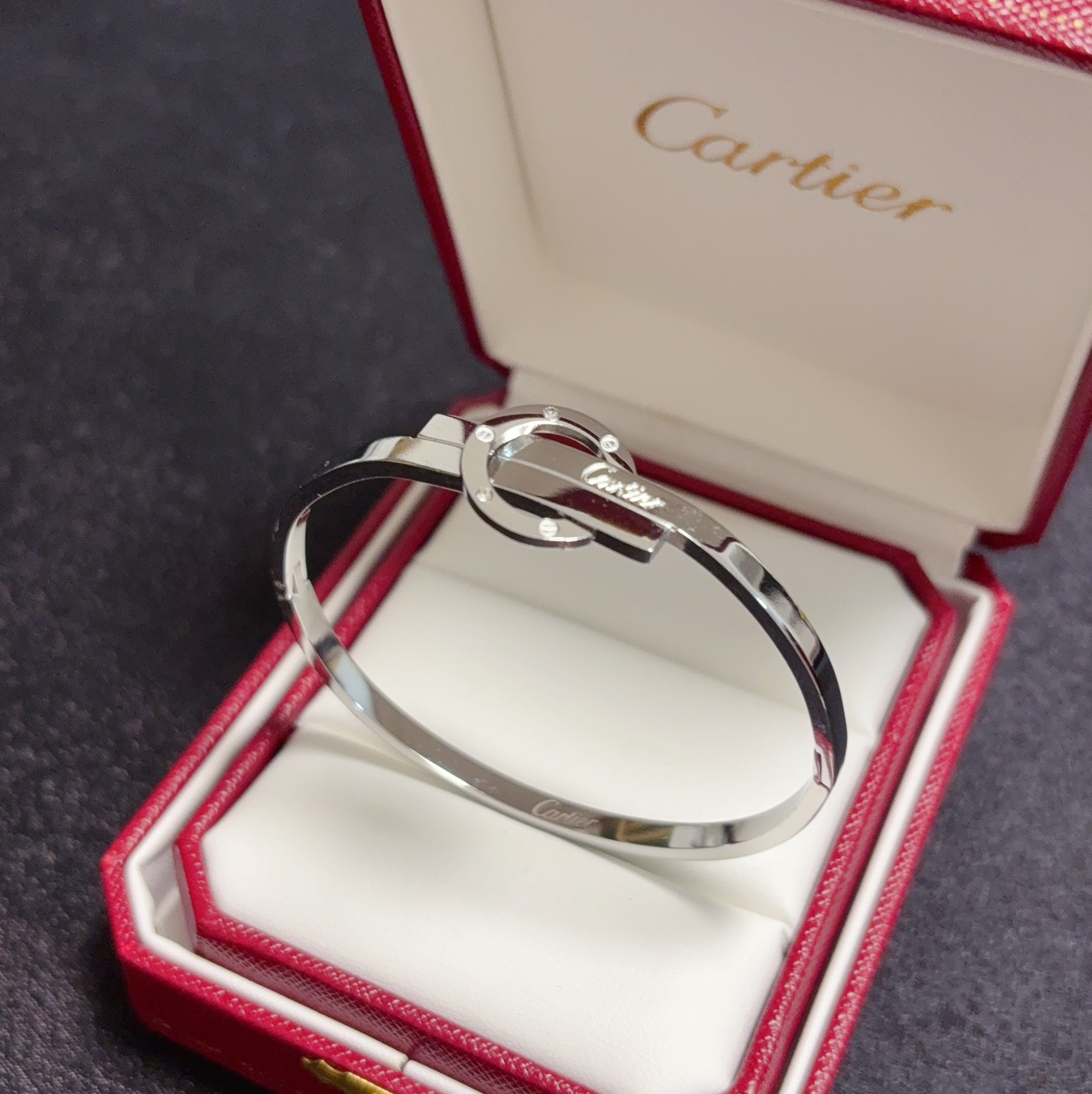 Cartier Love Interlocking Clasp Bangle bracelet 18k yellow gold with small clear diamond accents 18k white gold with small clear diamond accents 17cm inner circumference