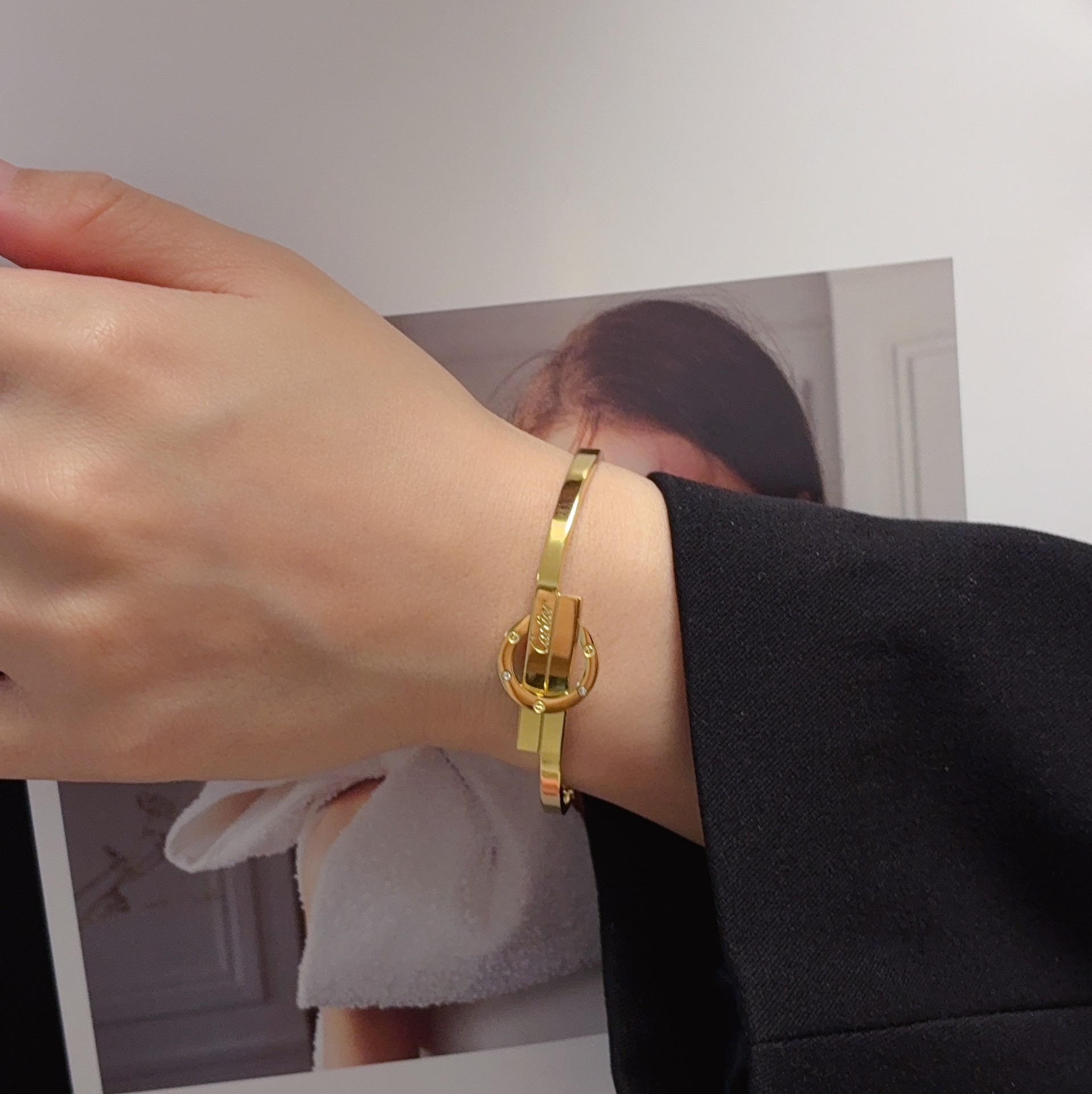Cartier Love Interlocking Clasp Bangle bracelet 18k yellow gold with small clear diamond accents 18k white gold with small clear diamond accents 17cm inner circumference