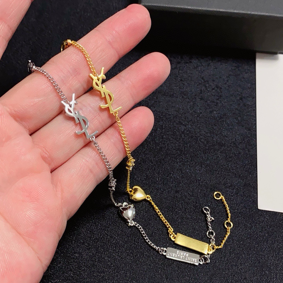 Saint Laurent YSL Monogram Heart Charm bracelet gold-tone metal with clear crystal accent 18cm