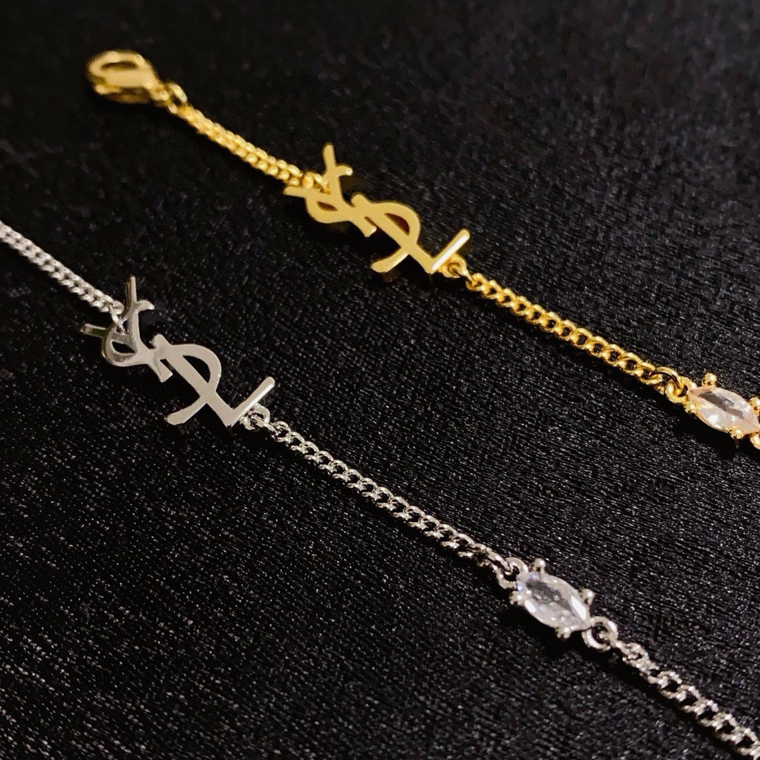 Saint Laurent YSL Monogram Heart Charm bracelet gold-tone metal with clear crystal accent 18cm