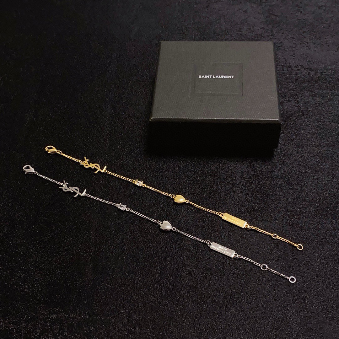 Saint Laurent YSL Monogram Heart Charm bracelet gold-tone metal with clear crystal accent 18cm