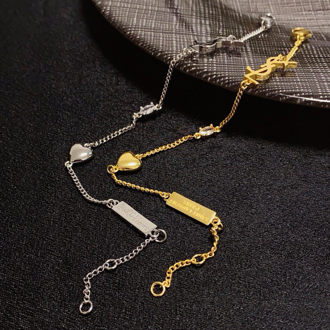 Saint Laurent YSL Monogram Heart Charm bracelet gold-tone metal with clear crystal accent 18cm