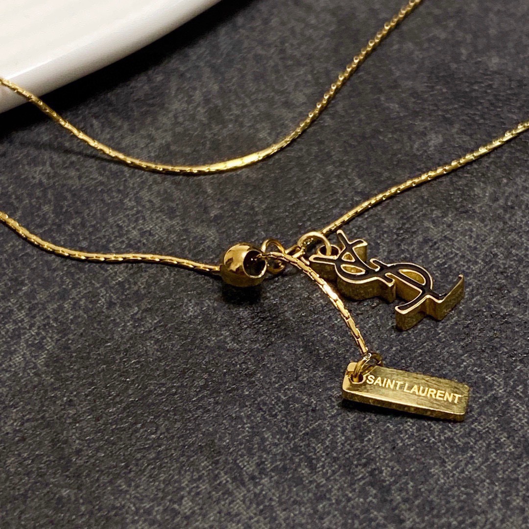 Saint Laurent Cassandre YSL Lariat necklace gold-tone metal with black enamel logo detail 40cm with 5cm extender