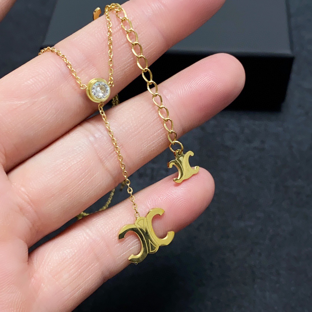 Celine Triomphe Multi-Logo Lariat necklace 14K gold-toned metal with clear cubic zirconia accents 45cm with 5cm extender