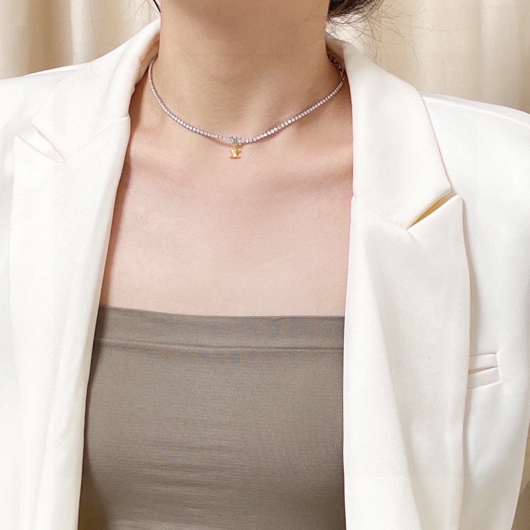 Celine Triomphe necklace silver-toned metal with clear cubic zirconia gold-toned Triomphe charm 38cm