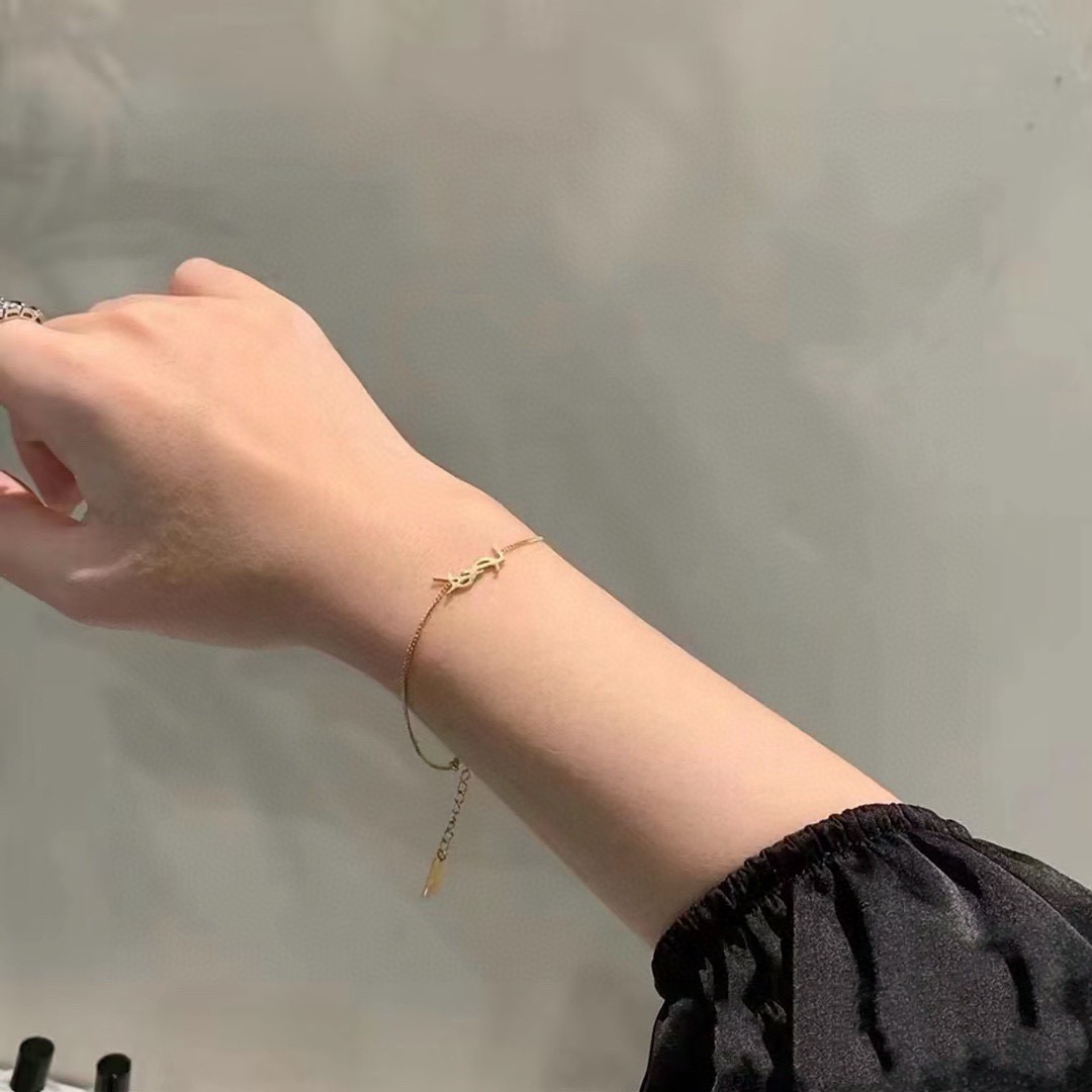Saint Laurent Cassandre YSL Logo bracelet gold-tone metal no gemstones 16cm with 3cm extender