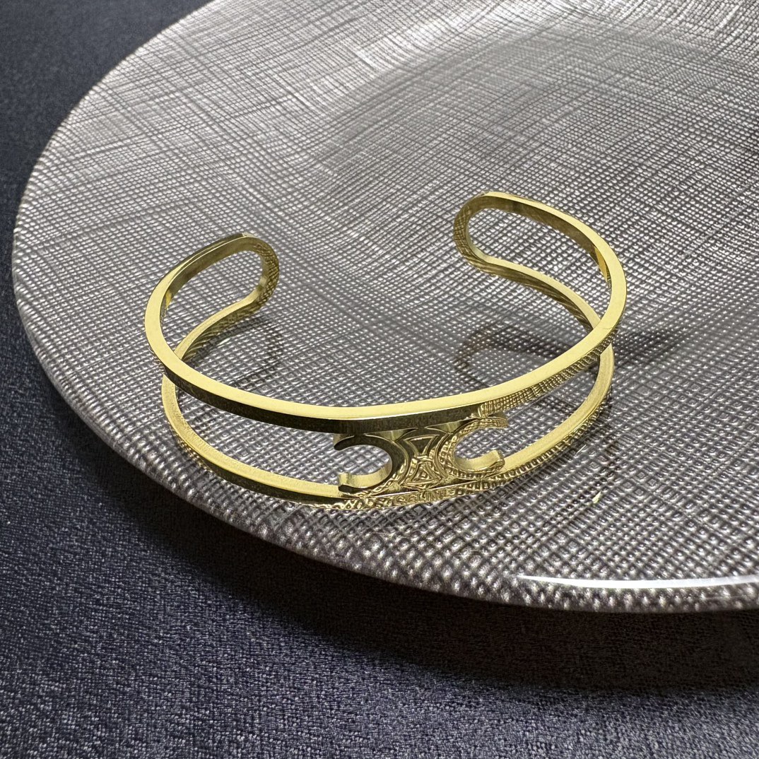 Celine Triomphe Open Cuff bracelet Gold-tone metal no accent stones Adjustable open cuff fits 15-18cm wrist
