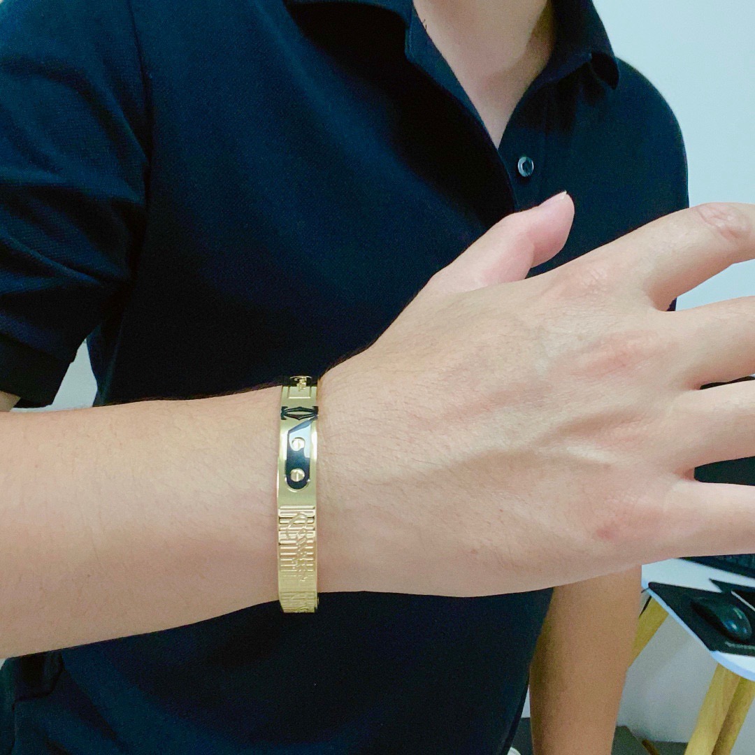 Cartier Love C de Cartier Decor Motif Bangle bracelet Multiple colorways silver-tone with black and red accents black with gold accents blue with gold accents rose gold-tone with black accents yellow gold-tone with black accents all with polished metal finishes and black enamel decorative details 21cm