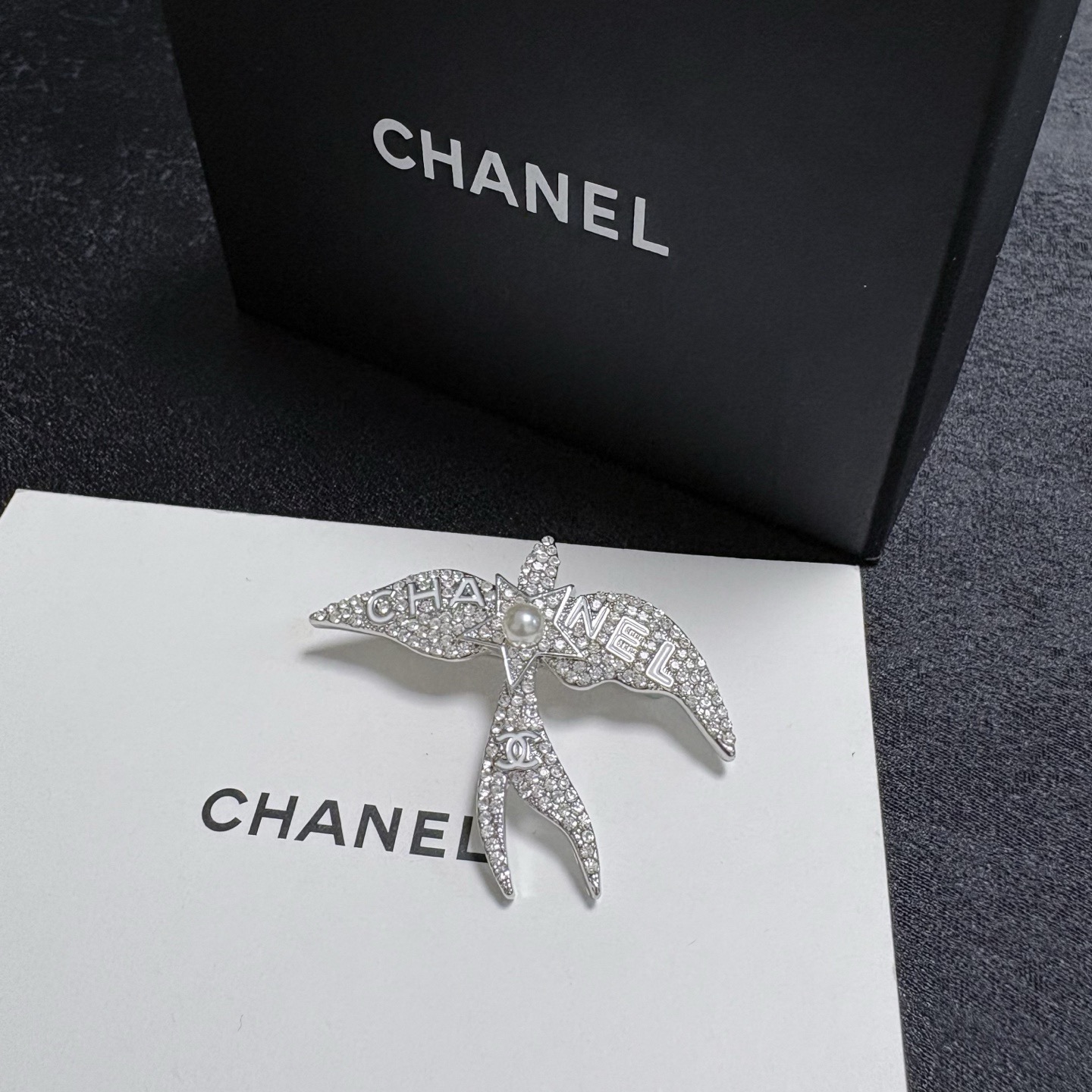 Chanel Crystal Pearl Swallow CC Logo Brooch brooch Silver-toned metal clear crystal white pearl Approximately 4 5cm width x 4cm height