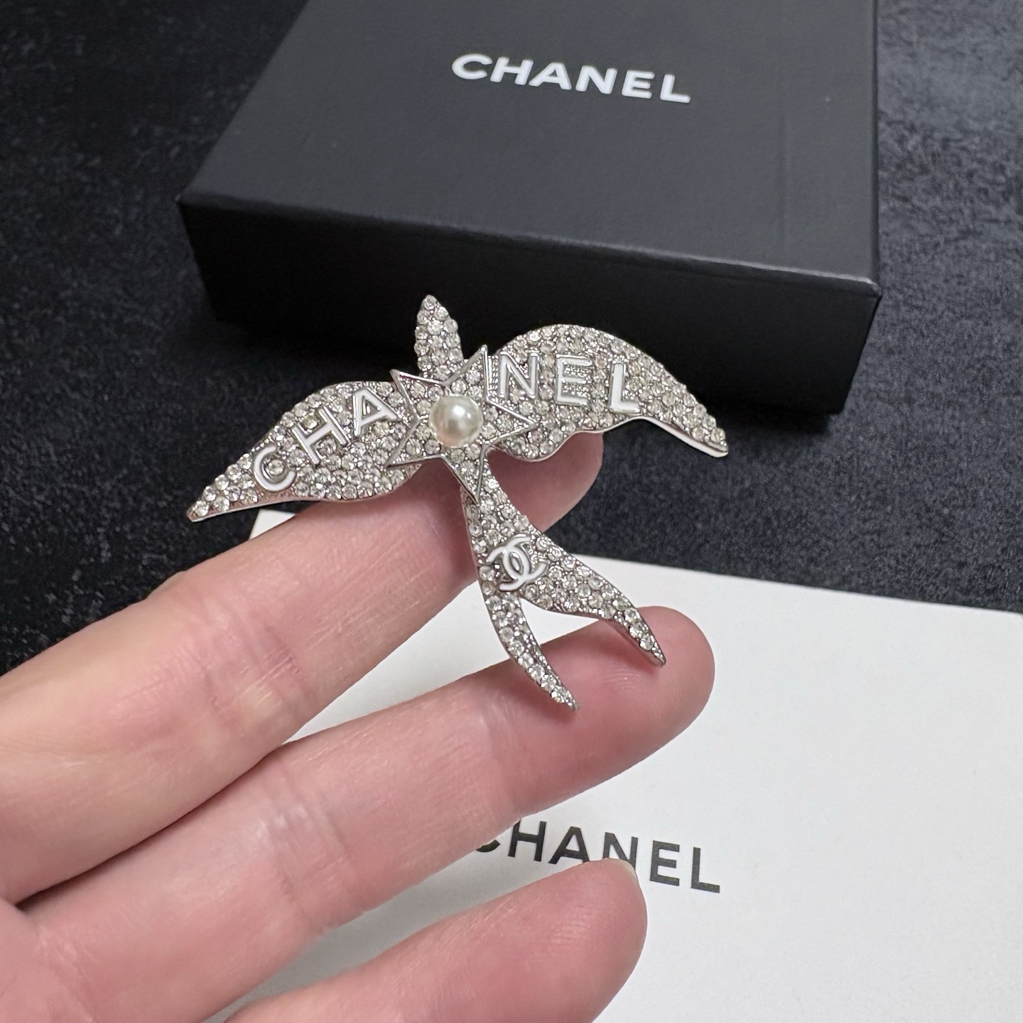 Chanel Crystal Pearl Swallow CC Logo Brooch brooch Silver-toned metal clear crystal white pearl Approximately 4 5cm width x 4cm height