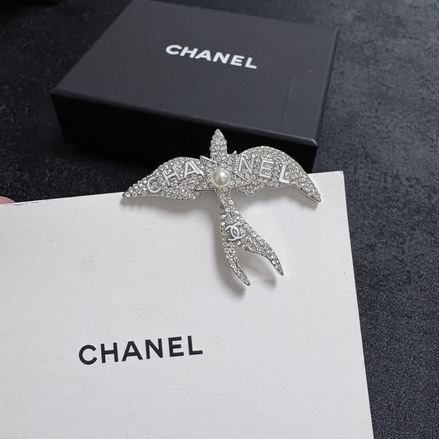 Chanel Crystal Pearl Swallow CC Logo Brooch brooch Silver-toned metal clear crystal white pearl Approximately 4 5cm width x 4cm height
