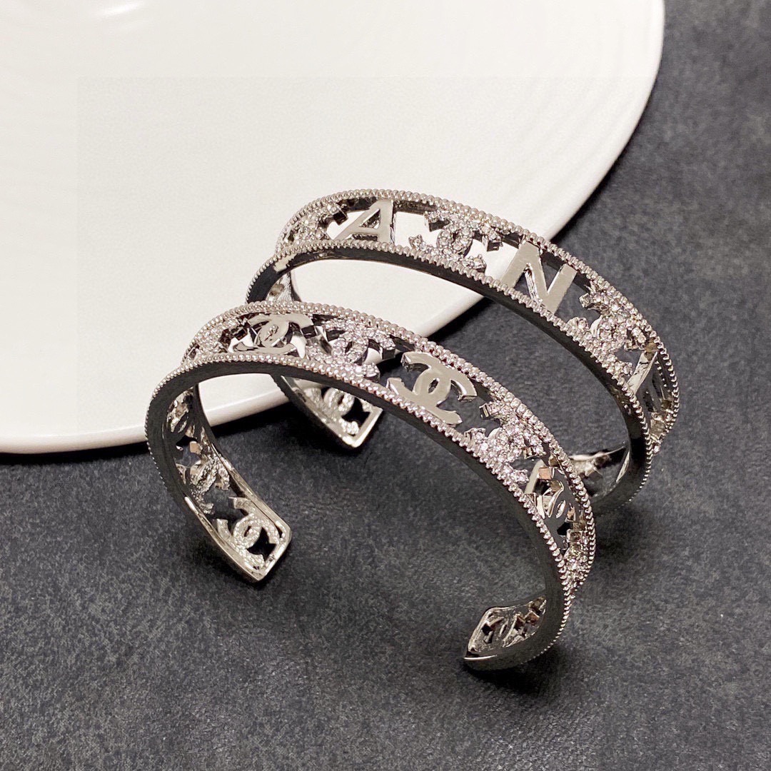 Chanel CC Logo Cutout Crystal Cuff bracelet silver-toned metal with clear crystal accents 17cm inner circumference