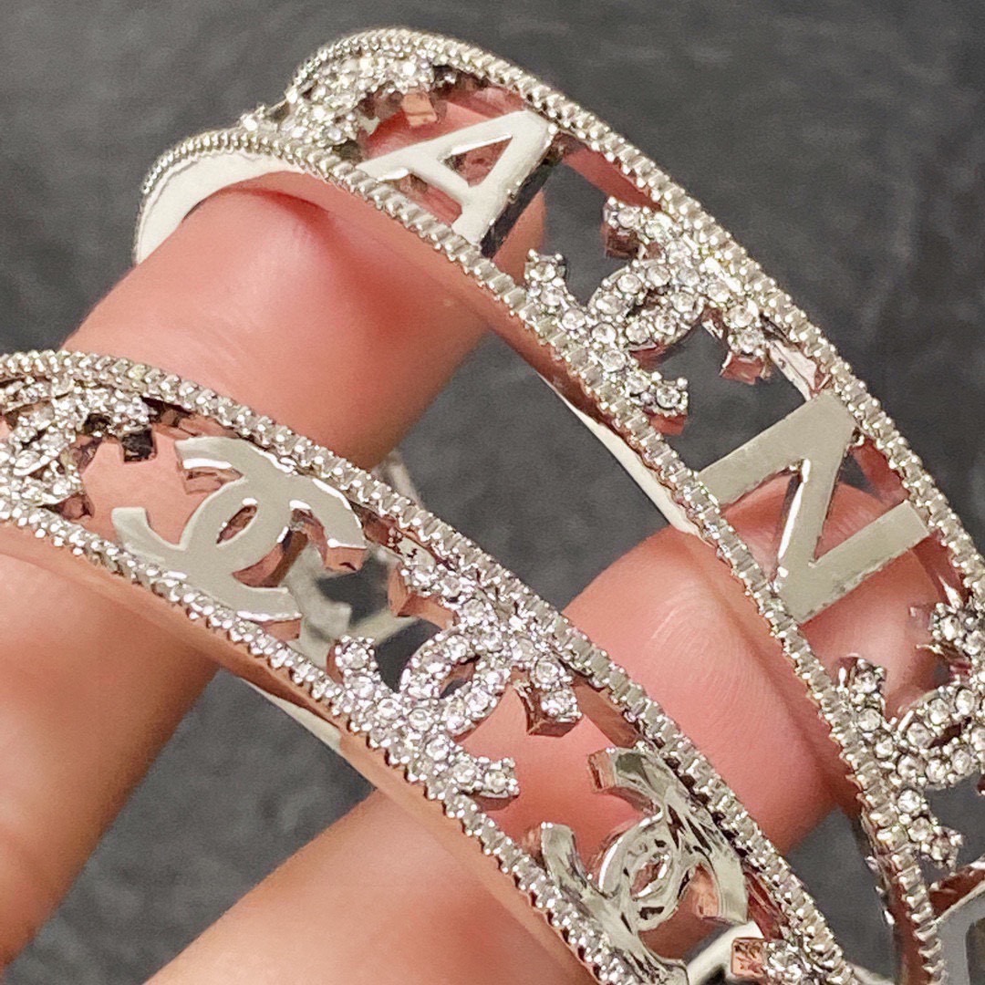 Chanel CC Logo Cutout Crystal Cuff bracelet silver-toned metal with clear crystal accents 17cm inner circumference