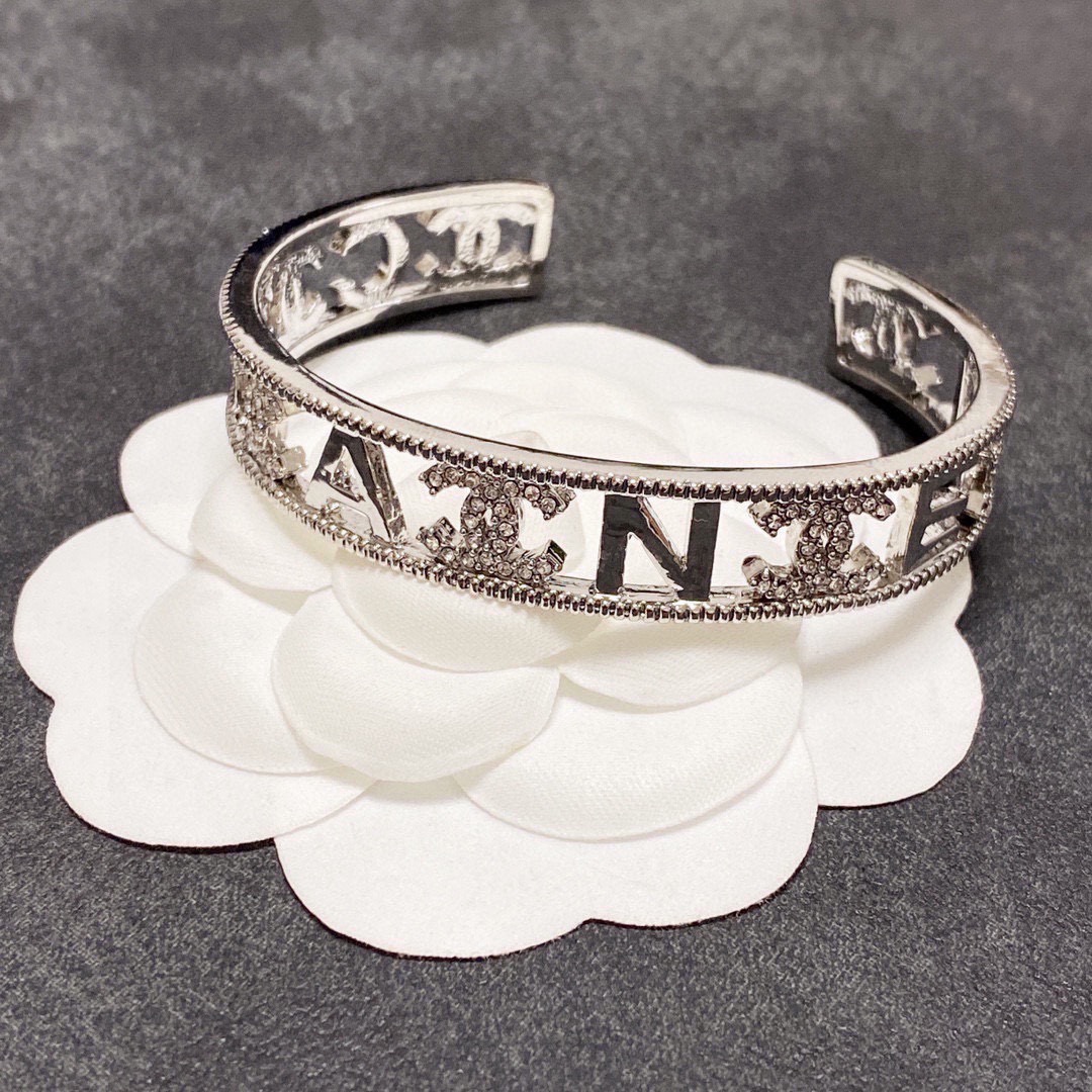 Chanel CC Logo Cutout Crystal Cuff bracelet silver-toned metal with clear crystal accents 17cm inner circumference