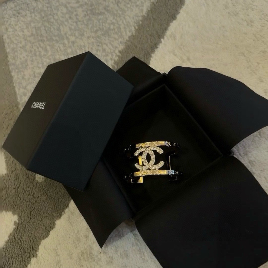 Chanel CC Logo Quilted Crystal Cuff bracelet gold-tone metal with clear crystal accents 17cm inner circumference
