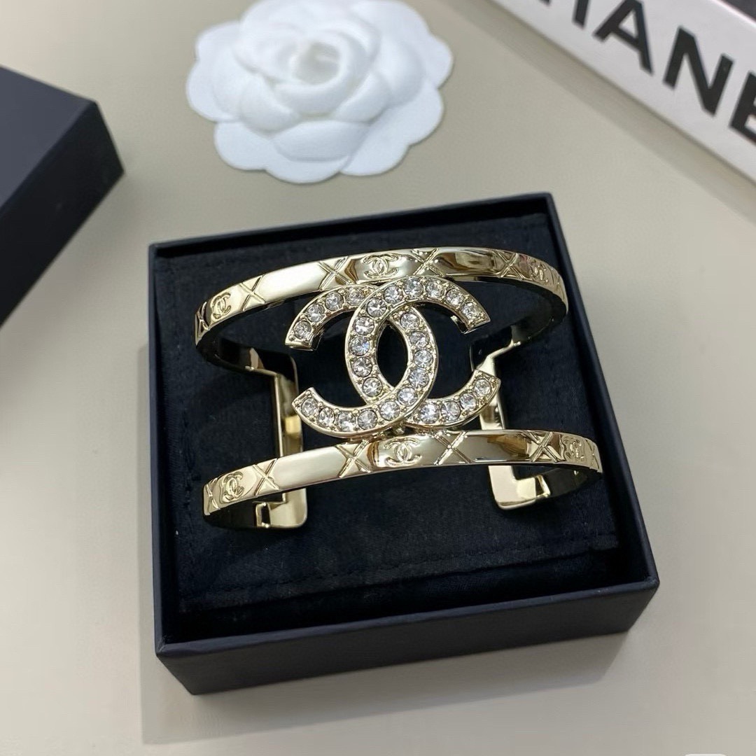 Chanel CC Logo Quilted Crystal Cuff bracelet gold-tone metal with clear crystal accents 17cm inner circumference