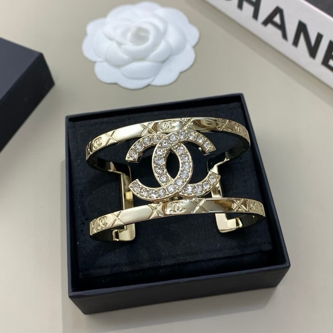 Chanel CC Logo Quilted Crystal Cuff bracelet gold-tone metal with clear crystal accents 17cm inner circumference