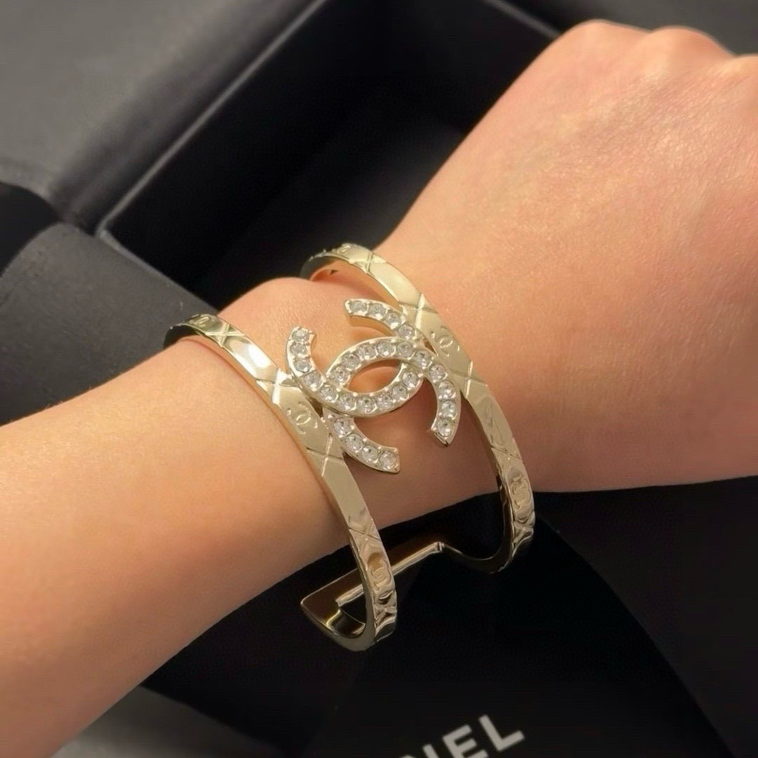 Chanel CC Logo Quilted Crystal Cuff bracelet gold-tone metal with clear crystal accents 17cm inner circumference