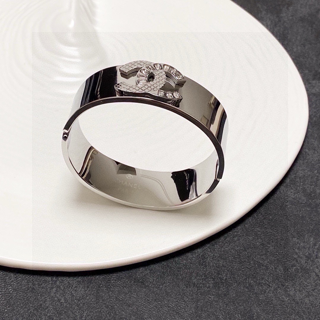 Chanel CC Logo Quilted Crystal Wide Cuff bracelet Silver-tone metal with clear baguette-cut crystals One Size standard wide cuff inner circumference 17cm