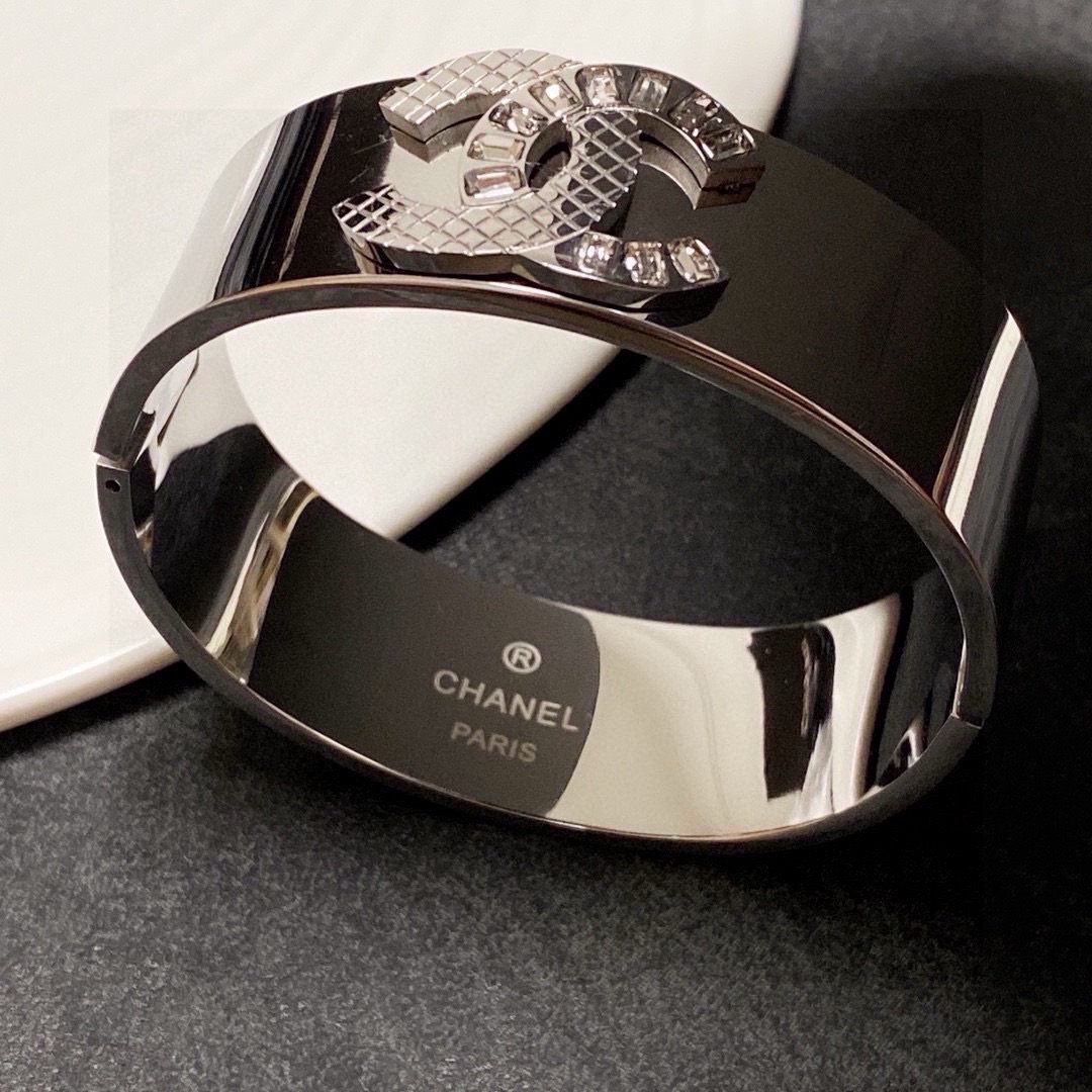 Chanel CC Logo Quilted Crystal Wide Cuff bracelet Silver-tone metal with clear baguette-cut crystals One Size standard wide cuff inner circumference 17cm