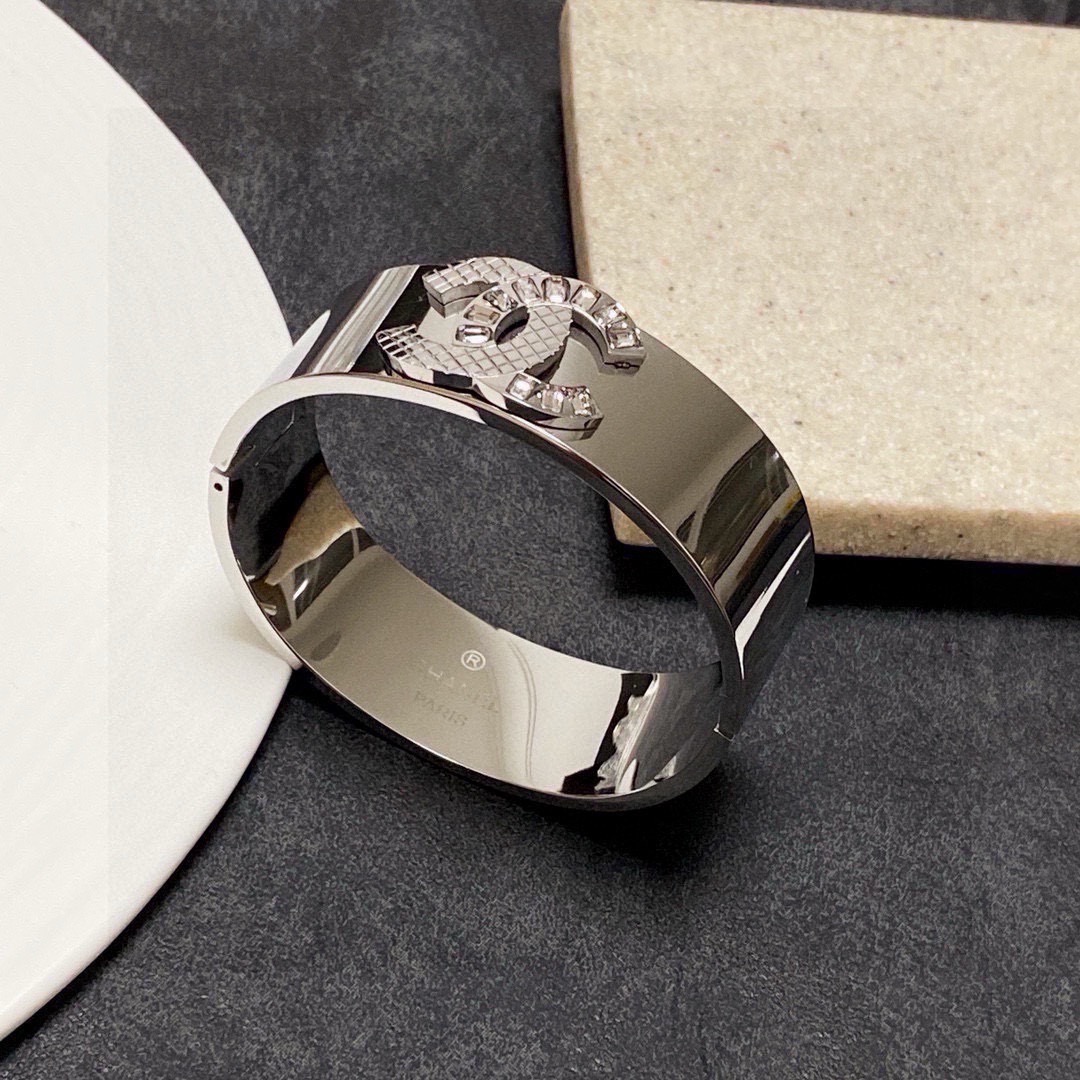 Chanel CC Logo Quilted Crystal Wide Cuff bracelet Silver-tone metal with clear baguette-cut crystals One Size standard wide cuff inner circumference 17cm
