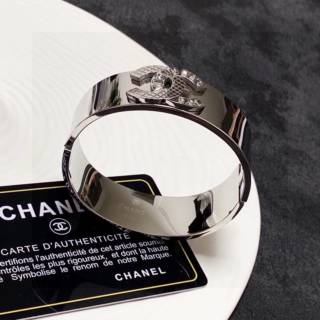 Chanel CC Logo Quilted Crystal Wide Cuff bracelet Silver-tone metal with clear baguette-cut crystals One Size standard wide cuff inner circumference 17cm