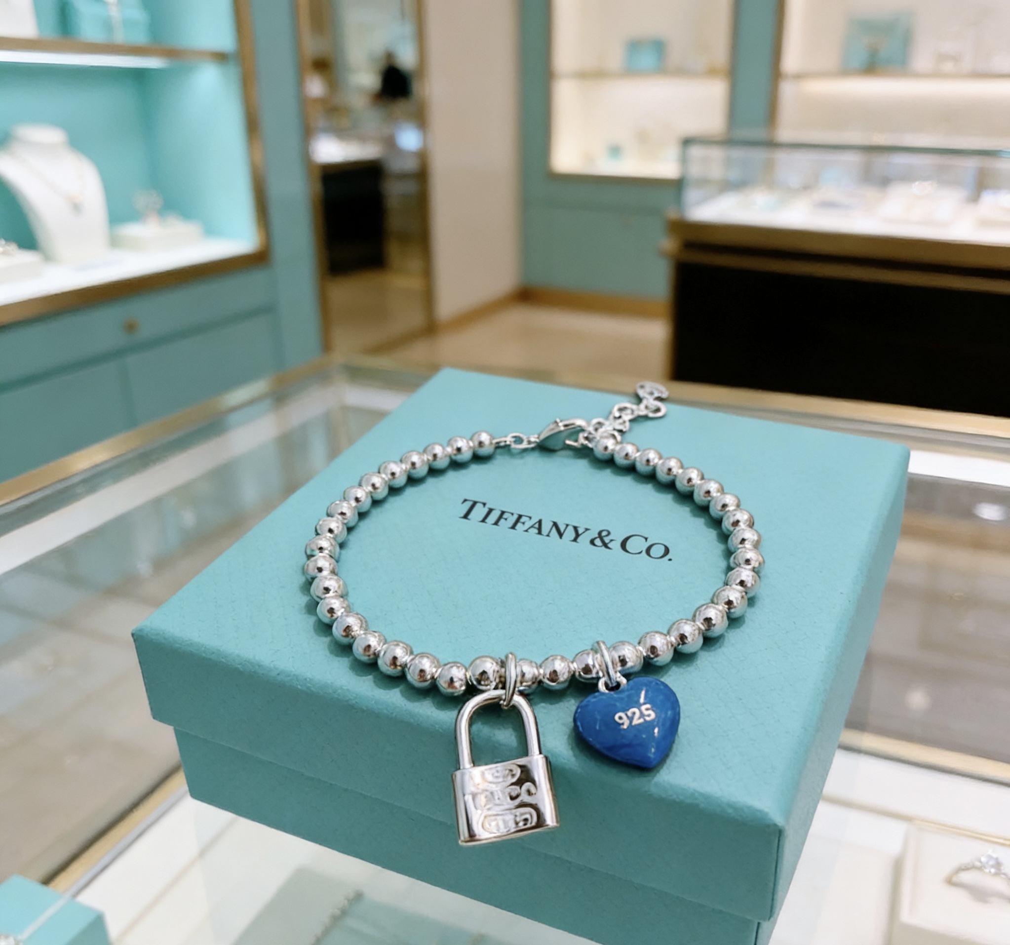 Tiffany Co Return to Tiffany Bead Bracelet with Blue Heart Tag and Lock Charm bracelet Sterling silver with blue enamel heart charm 18cm