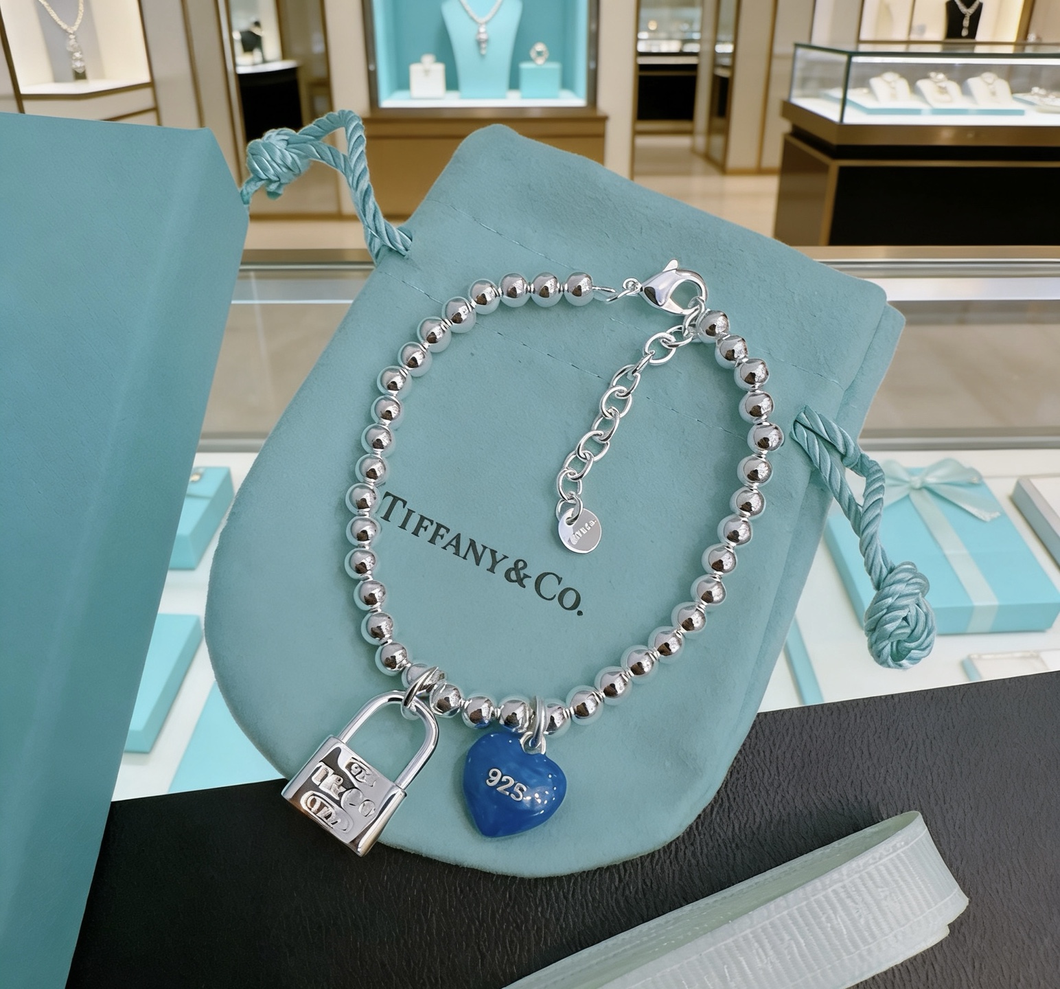 Tiffany Co Return to Tiffany Bead Bracelet with Blue Heart Tag and Lock Charm bracelet Sterling silver with blue enamel heart charm 18cm