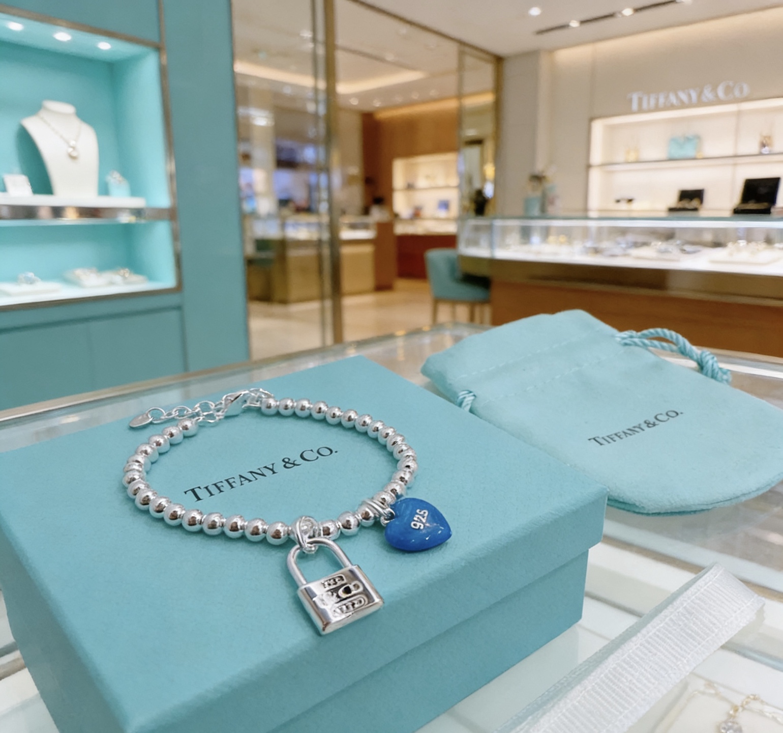 Tiffany Co Return to Tiffany Bead Bracelet with Blue Heart Tag and Lock Charm bracelet Sterling silver with blue enamel heart charm 18cm