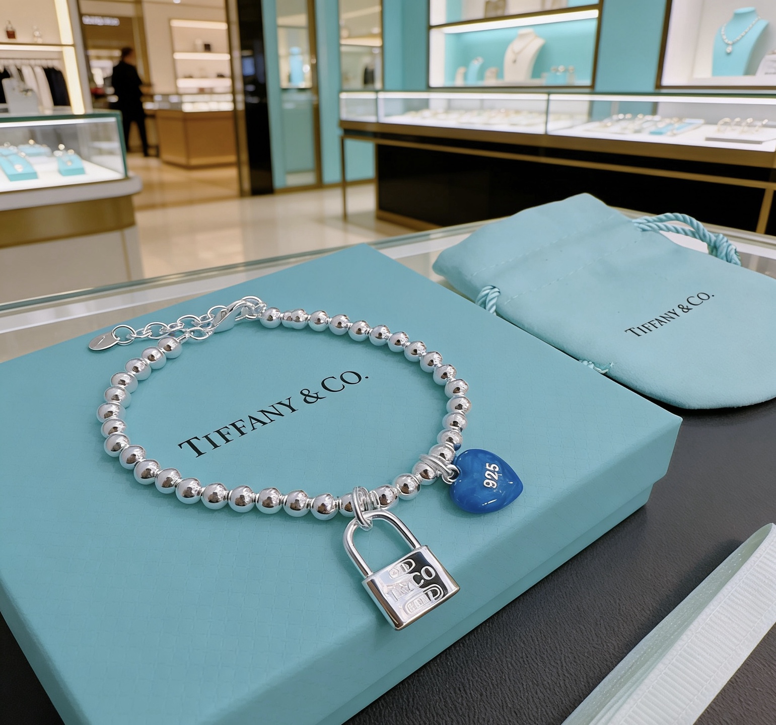 Tiffany Co Return to Tiffany Bead Bracelet with Blue Heart Tag and Lock Charm bracelet Sterling silver with blue enamel heart charm 18cm