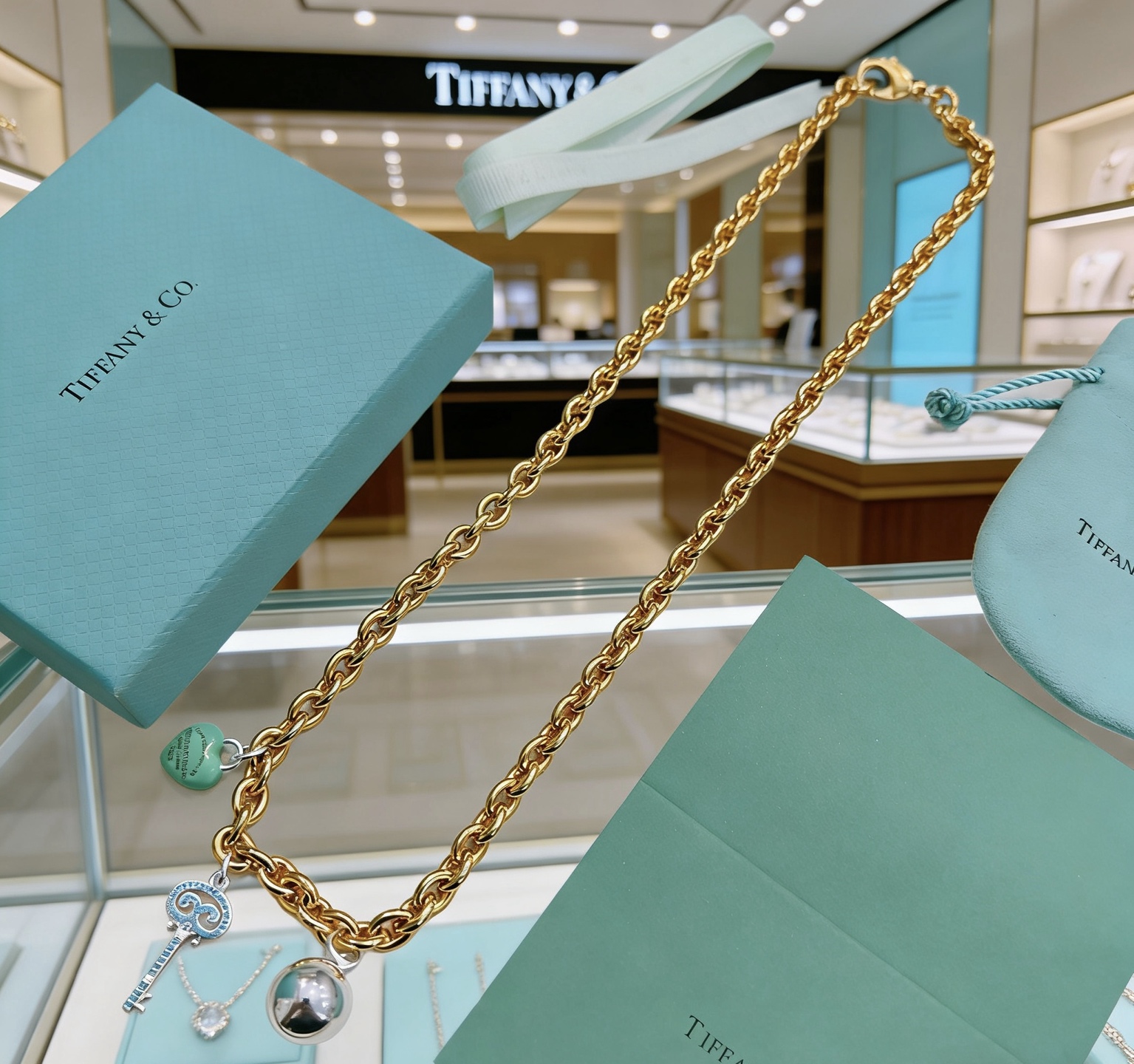Tiffany Co Return to Tiffany Charms necklace gold-tone metal silver-tone metal turquoise blue enamel clear diamond accents 18 inches