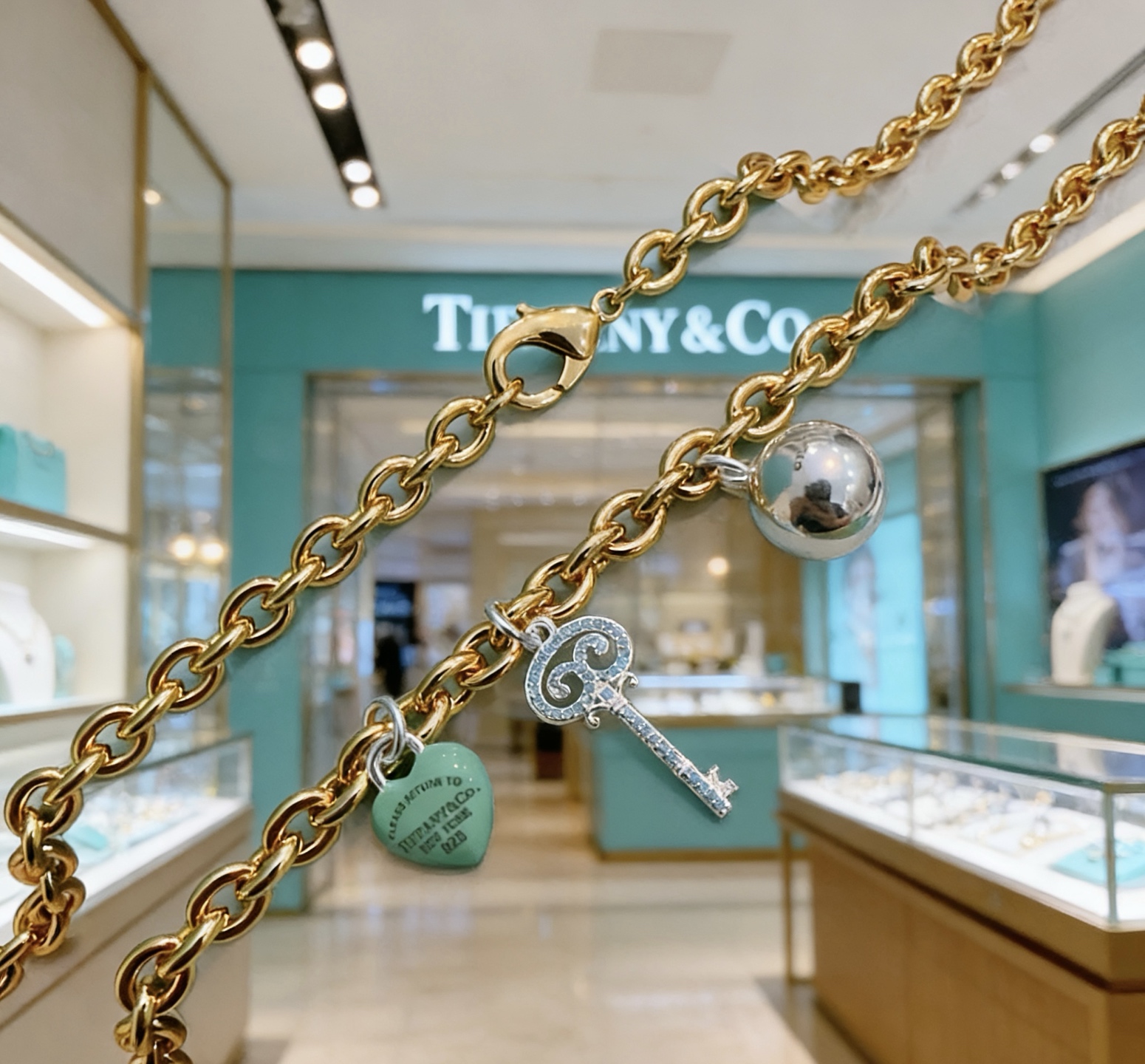 Tiffany Co Return to Tiffany Charms necklace gold-tone metal silver-tone metal turquoise blue enamel clear diamond accents 18 inches