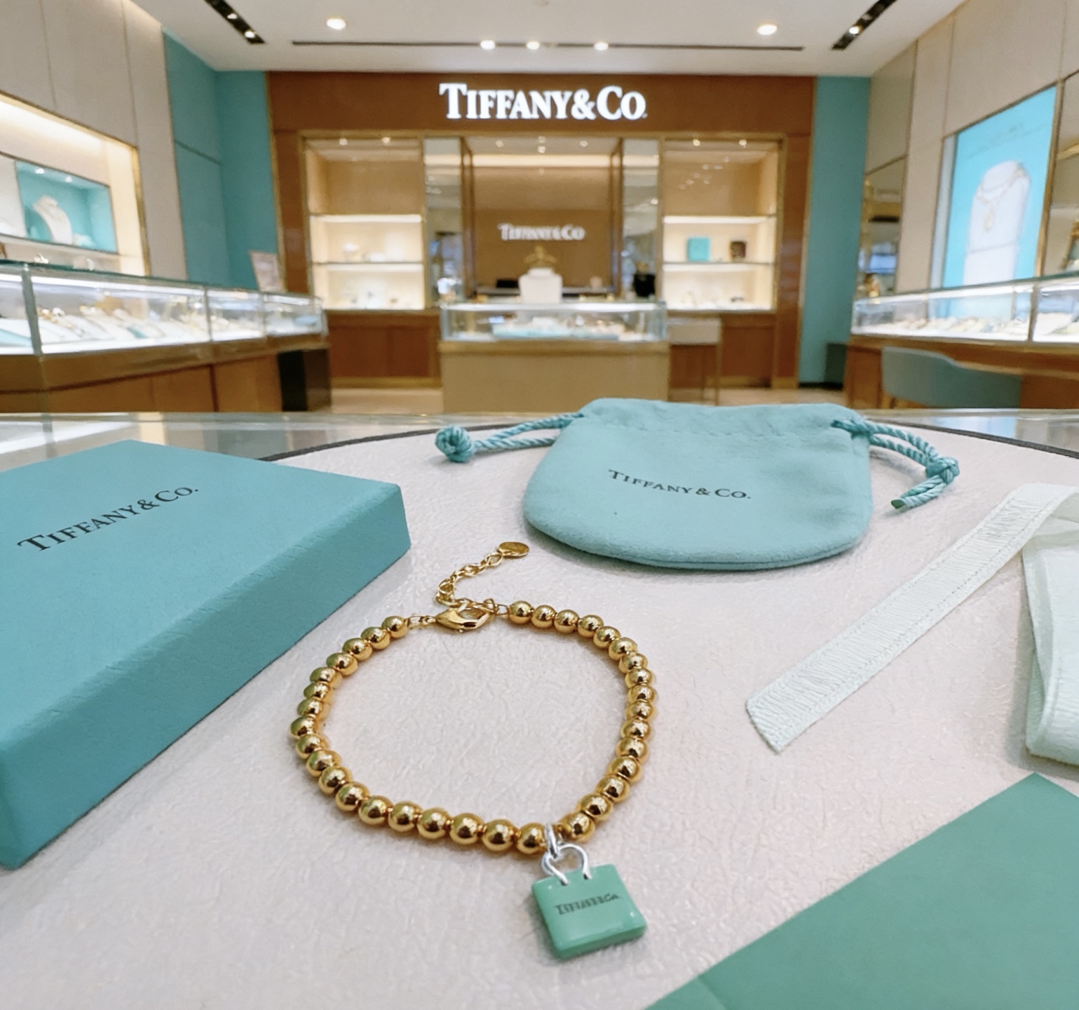 Tiffany Co Return to Tiffany Blue Padlock Charm Bead Collection necklace 18k gold tone metal with signature Tiffany blue enamel padlock charm silver tone hardware 18 inches