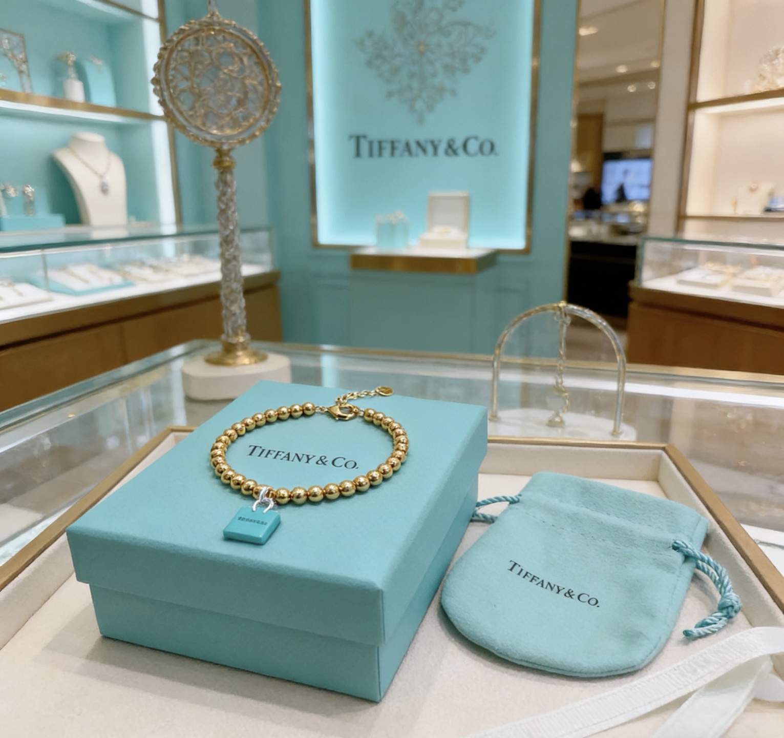 Tiffany Co Return to Tiffany Blue Padlock Charm Bead Collection necklace 18k gold tone metal with signature Tiffany blue enamel padlock charm silver tone hardware 18 inches