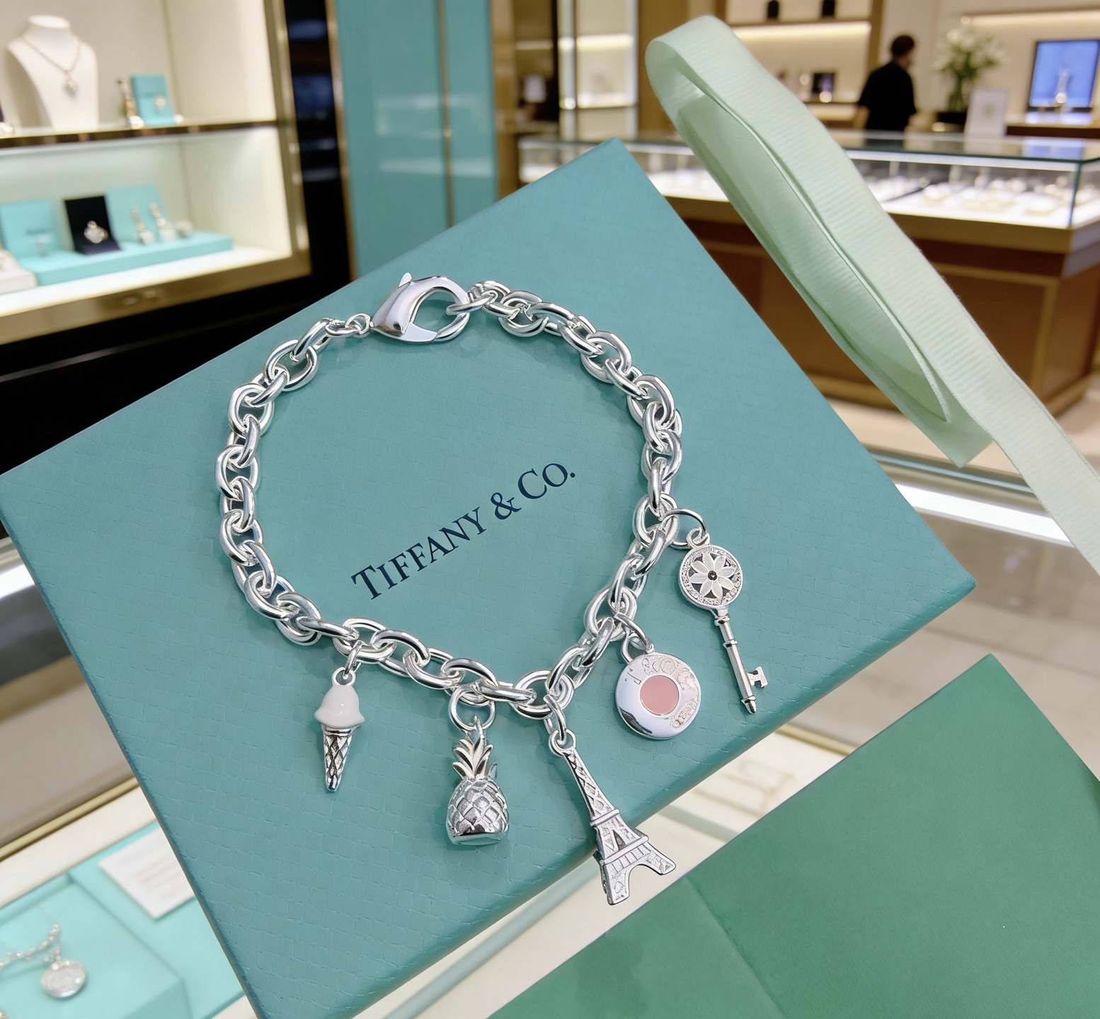 Tiffany Co Charm Bracelet bracelet Sterling silver with white enamel ice cream pink enamel round charm silver-toned pineapple Eiffel Tower and daisy key charms 7 inches