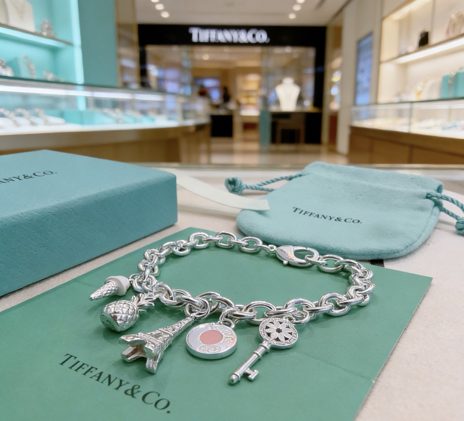 Tiffany Co Charm Bracelet bracelet Sterling silver with white enamel ice cream pink enamel round charm silver-toned pineapple Eiffel Tower and daisy key charms 7 inches