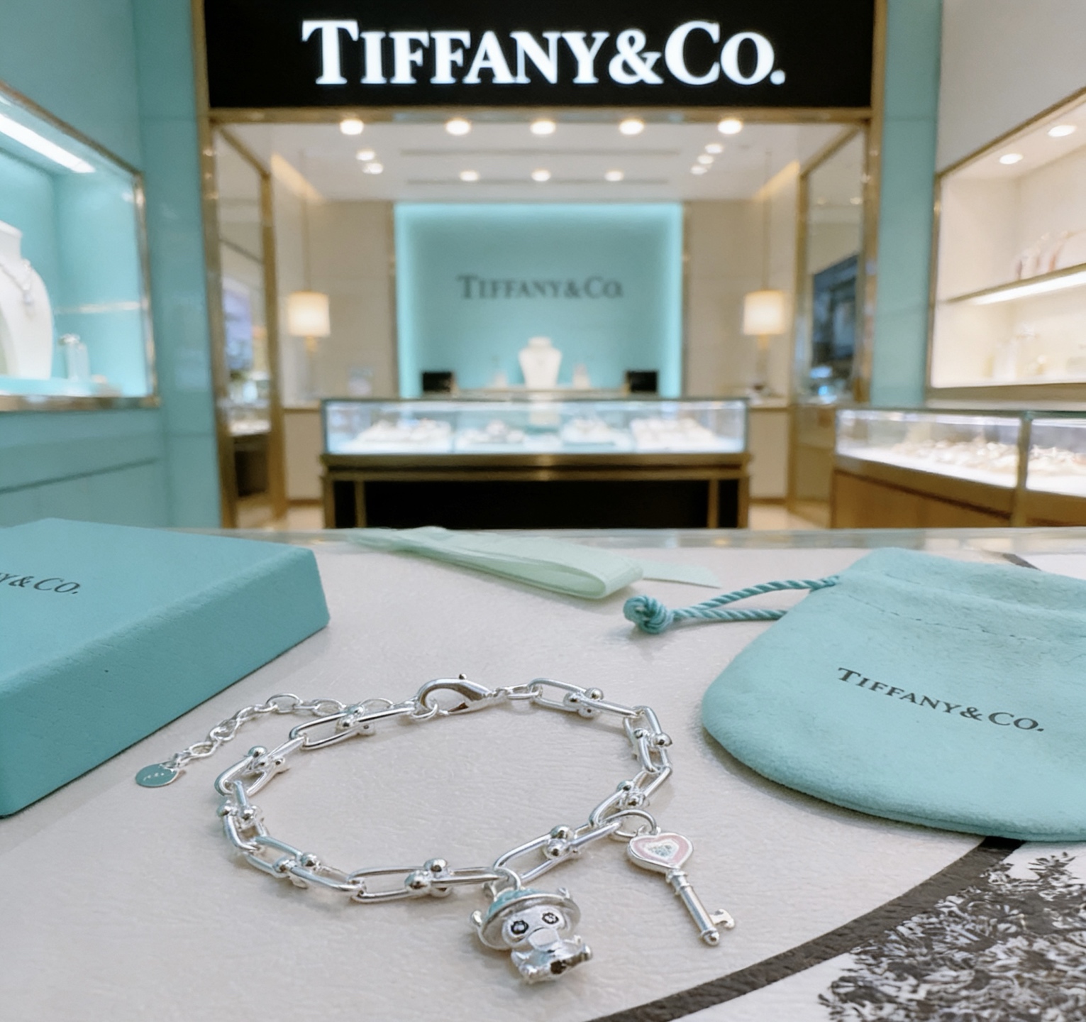 Tiffany Co HardWear Charm bracelet silver metal with light blue and pink enamel accents 18cm