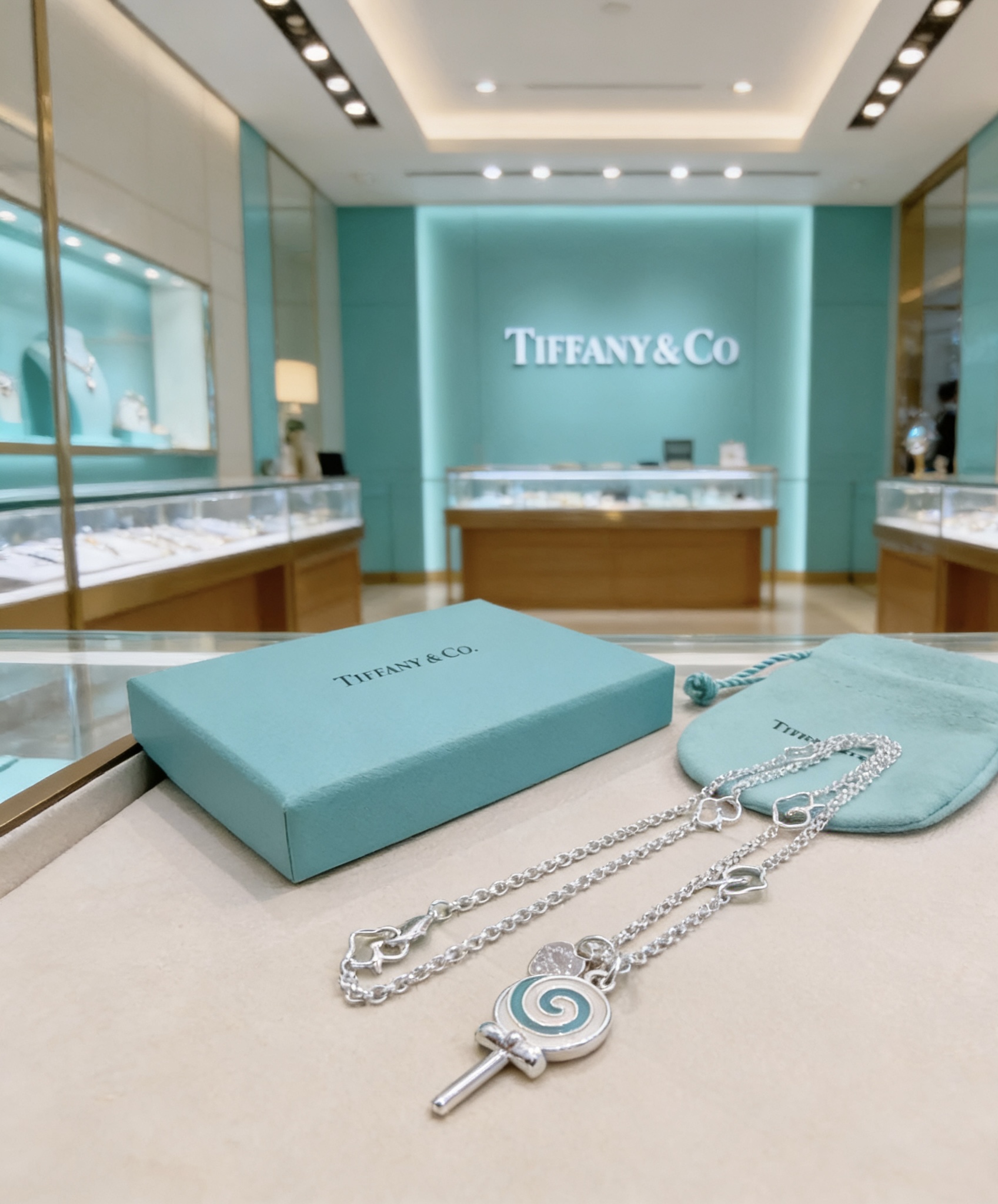 Tiffany Co Lollipop Charm necklace silver-toned metal with Tiffany blue and white enamel accented with clear pave stones on the attached heart tag 18 inches